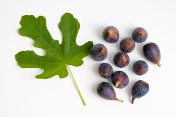 Figs fruits and leaf on white background, top view.