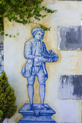 welcoming character in azulejos on a wall of a quinta in Setúbal