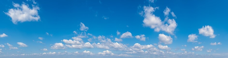 White cumulus clouds in blue sky panoramic high resolution background