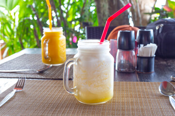 mango fruit cocktails stand on a table in a cafe