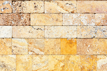 The wall is faced with hewn yellow shell stone.