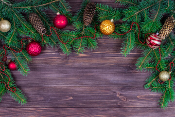 Fototapeta na wymiar Christmas tree with decoration on a dark wooden background. View from above. Place for an inscription. New Year. Christmas