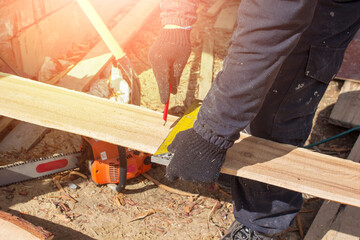 The carpenter draws a line on the Board with a ruler. The concept of the construction