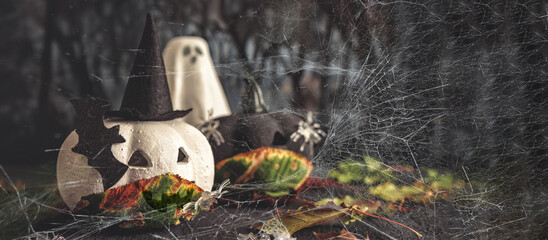 Happy halloween holiday. Halloween decorations, black and white pumpkins mask coronavirus,bats, ghosts black background. Halloween party greeting card mockup with copy space. Halloween greeting banner