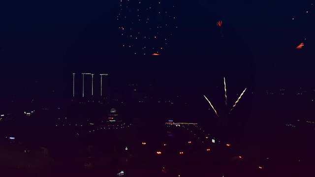Celebratory fireworks in the night sky against the background of the night city.