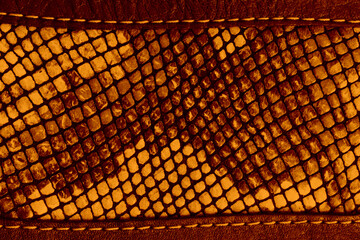Brown greasy leather texture. Embroidery patterns on red leather