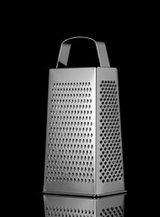 Shiny Stainless Steel Grater Isolated on black background.