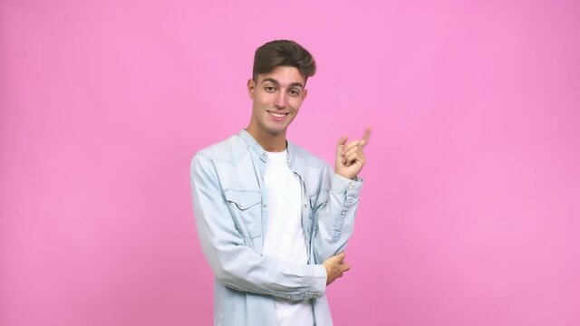 Young student teenager man cheerful smiles pointing to front