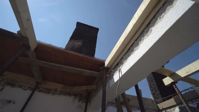 Wooden slats with sun shining through and burnt construction, fire accident house renovation