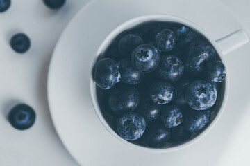 Blueberry in a white cup, view from above