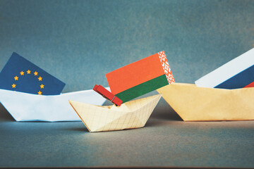 paper boat with the flag of belarus  and russia,  europe.