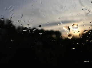 Raindrops on the evening window, dark window with raindrops