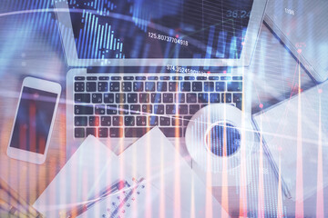 Stock market chart and top view computer on the table background. Double exposure. Concept of financial analysis.