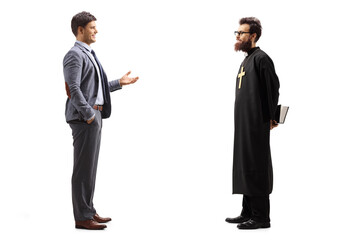 Man gesturing with hand and talking to a catholic priest