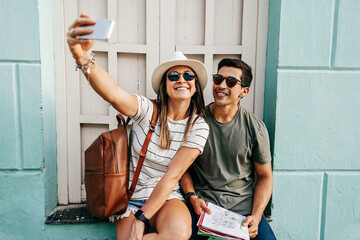 Happy tourist couple taking self portrait. Travel and love concept in Latin America