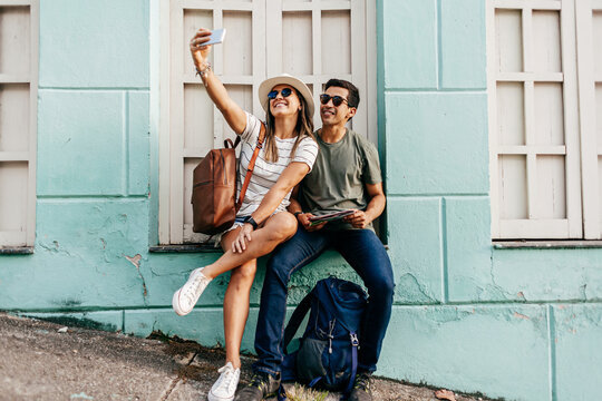 Happy tourist couple taking self portrait. Travel and love concept in Latin America