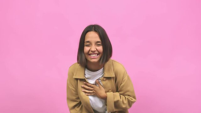 Young indian woman laughing and having fun, being relaxed and cheerful, feels confident and successful
