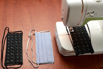 Sewing machine prepared to make face masks, on one side finished face masks