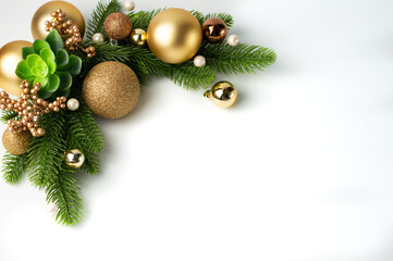 Christmas composition with fir branches and golden toys. Background for holiday cards, banners.