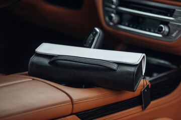 Women's handbag in the interior of a luxury car