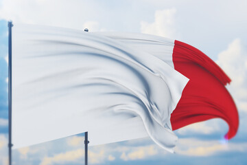 White flag on flagpole waving in the wind and flag of Malta. Closeup view, 3D illustration.