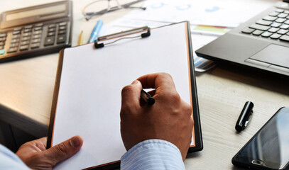 Finance and business concept. Business man working with laptop and documents. Mobile technologies, internet, vintage color, selective focus.