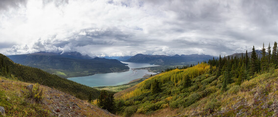 Naklejka premium Beautiful Panoramic View of a small Touristic Town, Carcross, surounded by Canadian Mountain Landscape. Located near Whitehorse, Yukon, Canada.