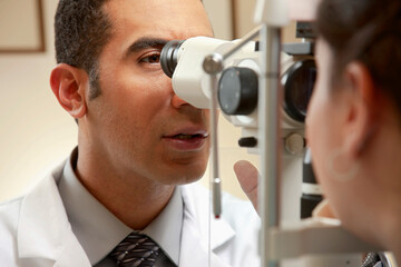 Optician examining patient's vision