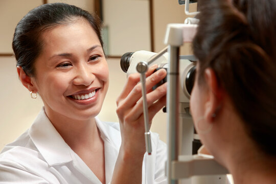 Optician examining patient's vision