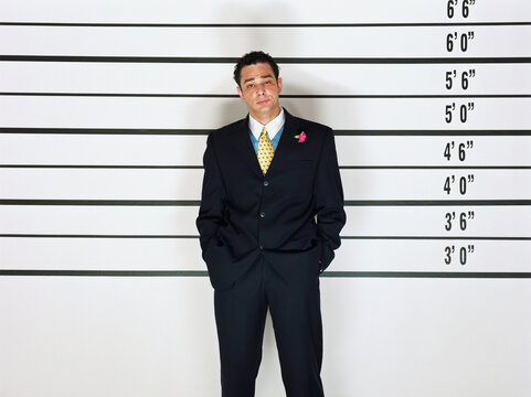 Hispanic man standing in police line-up