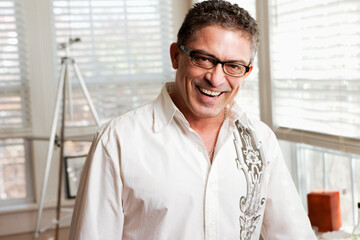 Hispanic artist standing in studio