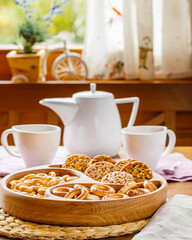 cups of tea and cookies on wooden table