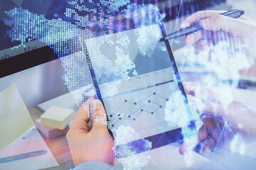 Double exposure of man's hands holding and using a phone and financial chart drawing. Market analysis concept.