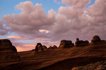 Landscape view of the Delicate Arch at sunset in Arches National Park after a thunderstorm (Utah).