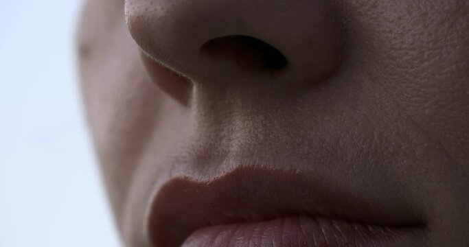 Tilting up close-up Female Face. Mouth Lips Nose Eyes. Outdoors Natural Lighting Morning Evening Time