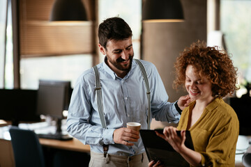 Businesswoman and businessman discussing work in office. Two friends in working together..