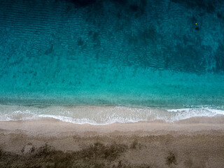 Waves crashing on the shores of Saranta Beach in the Aegean Sea at Pelion Peninsula, Greece. Photo taken whit drone.