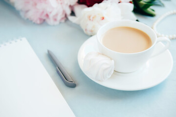 notebook pen and cup of coffee