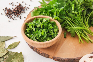 Bowl with fresh parsley and spices on white background