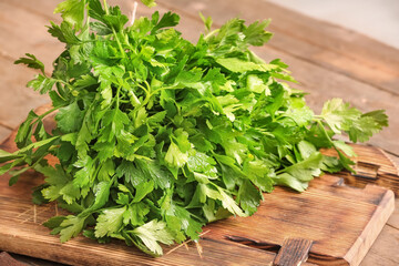 Board with fresh parsley on table, closeup