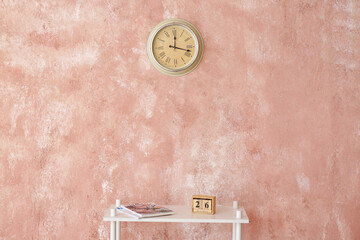 Table near wall with clock in room