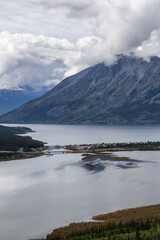 Beautiful View of a small Touristic Town, Carcross, surounded by Canadian Mountain Landscape. Located near Whitehorse, Yukon, Canada.