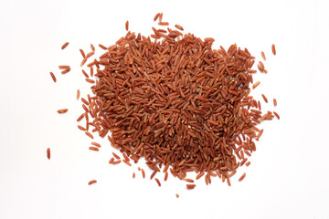 Raw brown rice top view. A handful of red rice on a white background.