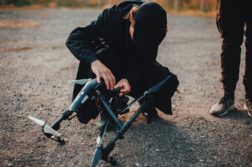 Technic prepare drone to fly outdoor. © Nik Viatkin