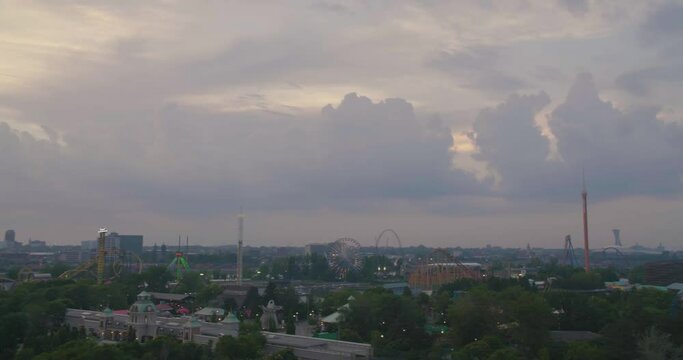Montreal, QC, Canada - April 15 , 2017: Pan shot of Six Flags, La Ronde park, Saint Helen's Island, Parc Jean Drapeau, from Jacques Cartier Bridge.