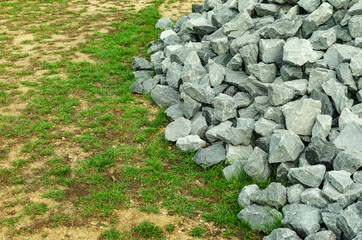 construction rocks, material for parks. Grass and soil background