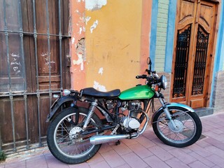 Green motorbike on a street in Valencia