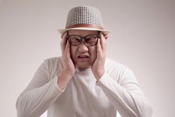 Asian Man Close His Eyes, Stress or Headache Concept