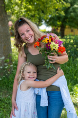 Attractive young mother and daughter in the countryside