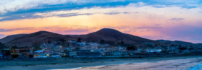 Panoramic sunrise over beach town, ocean